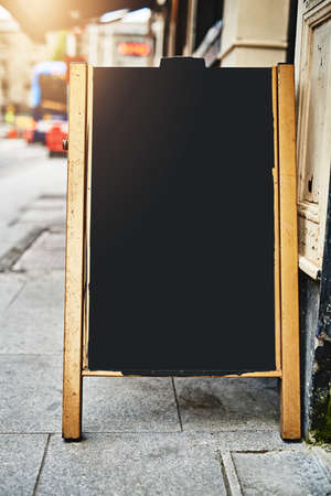 Guess whats on our menu today. Shot of a sidewalk sign with space for you to add your own text.の写真素材