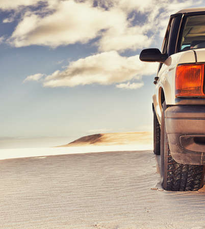 Venturing where few go. Shot of a heavy duty 4x4 driving along some sand dunes.の写真素材