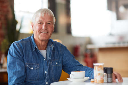 Kickstarting my day with coffee. Portrait of a relaxed senior man enjoying a cup of coffee in a...