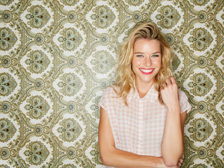 Just be your happy self. Shot of a young woman posing against a wallpaper background.の写真素材
