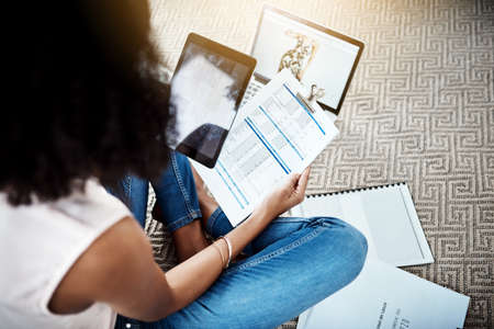 Making sure the paperwork is up to scratch. High angle shot of an unrecognizable young businesswoman...