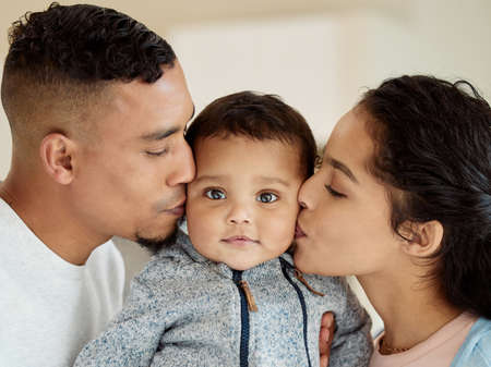Live with all our love inside of you. Shot of a young family bonding with their baby boy at home.の写真素材