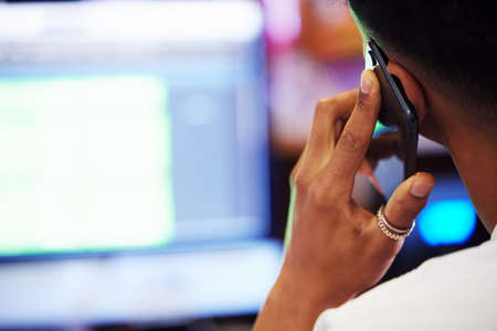 This sounds good. Rearview shot of an unrecognizable male music producer listening to his mix in the office.の写真素材