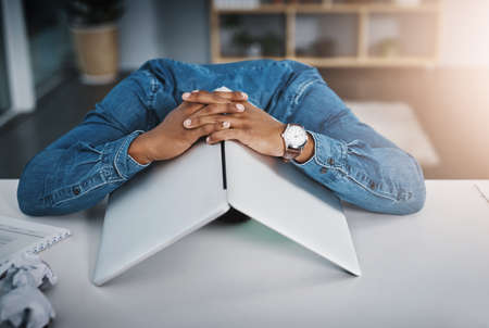 Its been a rough day for him. Shot of a businessman lying down on a desk with a laptop over his head...