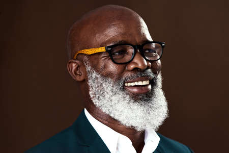 Great things await on the other side of fear. Studio shot of a mature businessman posing against a brown background.の写真素材