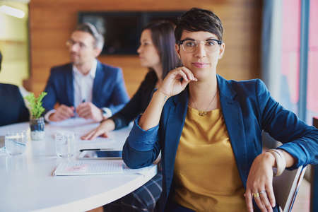 Bright minds fill this boardroom. Cropped portrait of a businesswoman sitting in the boardroom with her colleagues.の写真素材