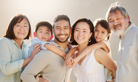 Family is everything. Cropped shot of a happy diverse multi-generational family at the beach.の写真素材