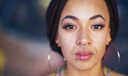 Going for bold. Portrait of an attractive young woman with piercings.の写真素材