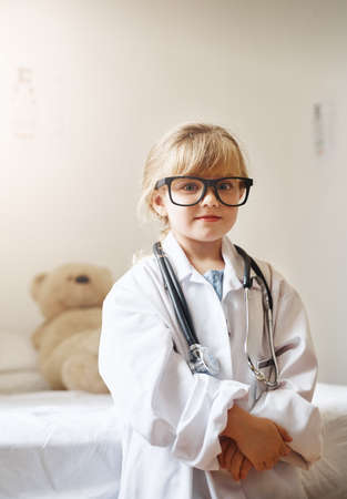 Mom said I can be anything I want. Portrait of an adorable little girl dressed up as a doctor.の写真素材
