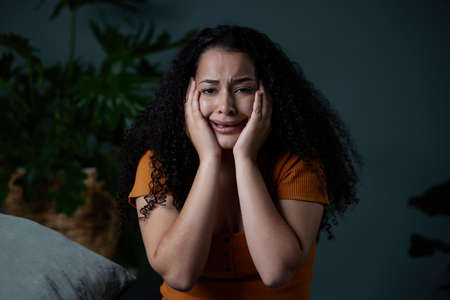 This was not supposed to end up like this. Shot of a young woman feeling unhappy at home.の写真素材