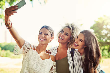 Social media id gonna love this. Shot of a group of friends taking a selfie together outdoors.