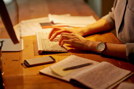 Shes typing up a storm. Shot of an unrecognizable businesswoman working late in the office.