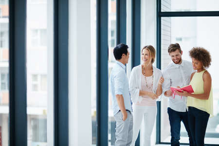 Good communication is the heart of a great team. Shot of a group of colleagues having a conversation...