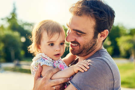 Daddy doesnt want to let you go. Shot of a young father with his little girl outdoors.の写真素材