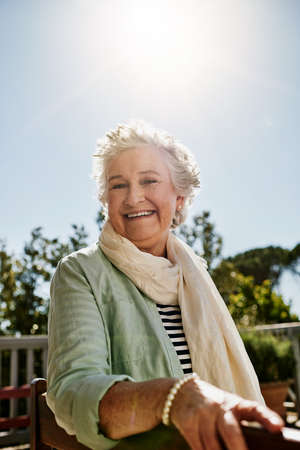 Happy days are here to stay. Portrait of a happy senior woman relaxing outdoors.