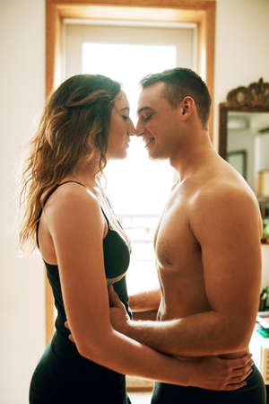 Mornings are for romance. Shot of an affectionate young couple spending a romantic morning together at home.の写真素材