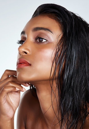 Nothing says gorgeous like glowing skin. Studio shot of a beautiful young woman posing against a light background.の写真素材