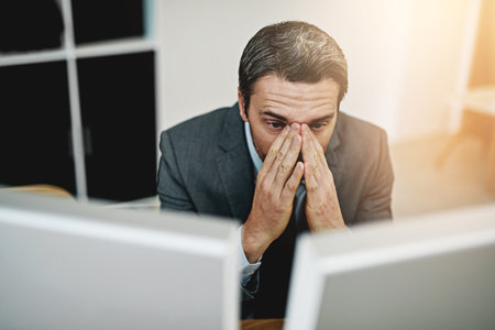 I messed up so badly. Shot of a mature businessman looking stressed out at his desk.