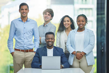 Making waves in the business sector. Shot of a team of businesspeople in their office together.の写真素材