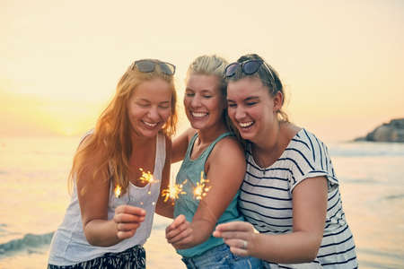 Celebrating our beach day. Shot of young female best friends hanging out at the beach.