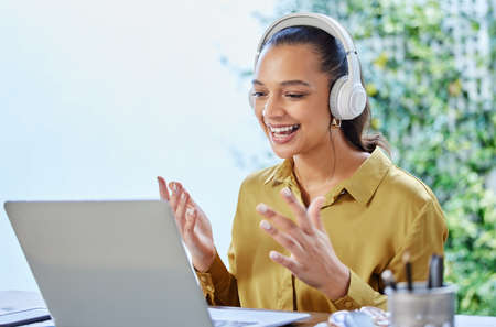 The new way of conducting meetings. Cropped shot of an attractive young businesswoman using her...