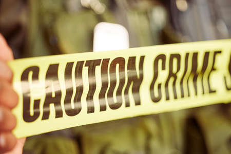Well take care of this from here. Shot of caution tape surrounding a crime scene.