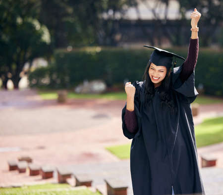 You only get what you work for. Cropped shot of an attractive young female student celebrating on graduation day.の写真素材