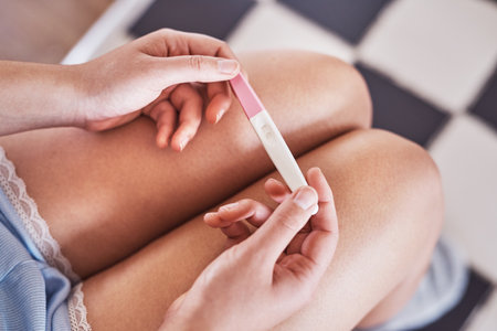Skipped your period. Cropped shot of an unrecognizable woman taking a pregnancy test at home.