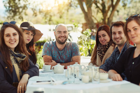 Getting together for lunch. Shot of a group of friends having lunch together.の写真素材