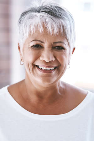 Her smile is still as great as ever. Portrait of a cheerful mature woman with a bright smile looking...