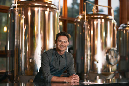 He knows the business in and out. Portrait of a cheerful young businessman seated at a table inside...