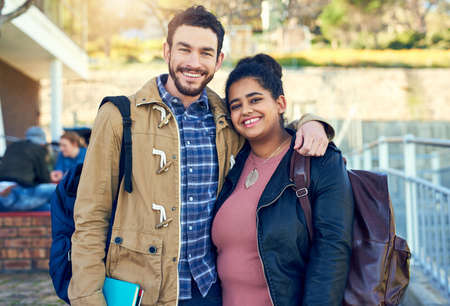 Time for education, we cant wait. Shot of college students between classes on campus grounds.の写真素材