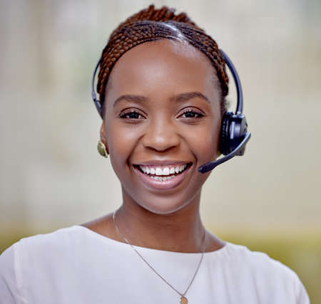 Planning is hard, let me help you. Portrait of a young woman using a headset in a modern office.
