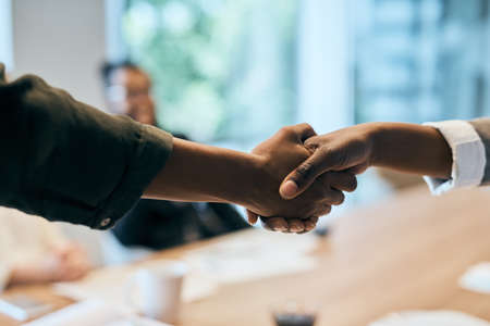 Looking forward to our next deal. Closeup of two unrecognizable businesspeople shaking hands in the...