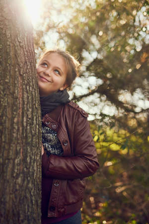 Adventure is out there. Shot of a little girl playing outdoors in a forest.の写真素材