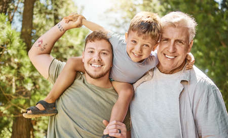 Boys trip. Cropped portrait of a handsome young man camping in the woods with his father and son.の写真素材