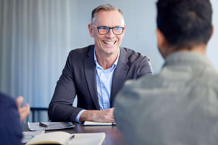 Devising big plans with the boss. Shot of two businessmen having a meeting in an office.