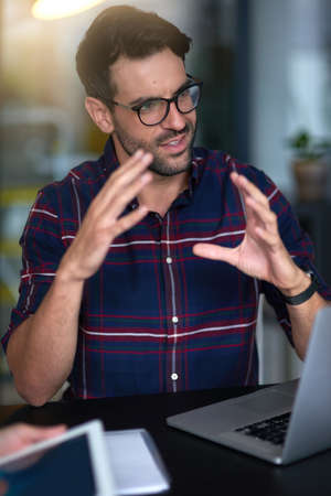 He has a clear vision for the company. Shot of a young professional leading his team through an idea...