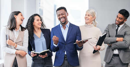 Celebrating the best parts of life. Shot of a team of businesspeople together at work.