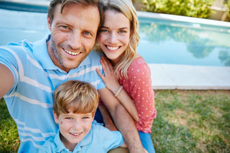 Capturing the moment to make it last forever. Portrait of a happy family taking a self-portrait...