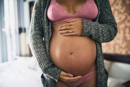 This is what life looks like. Cropped shot of an unrecognizable pregnant woman standing in her...