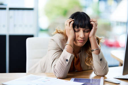 Im feeling so sleepy. Cropped shot of an attractive young businesswoman suffering from a headache...