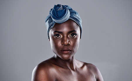 Your style speaks before you do. Shot of a beautiful young woman wearing a denim head wrap while...