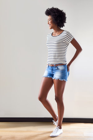 Stripes are still an awesome fashion staple. Shot of an attractive and happy young woman wearing a...