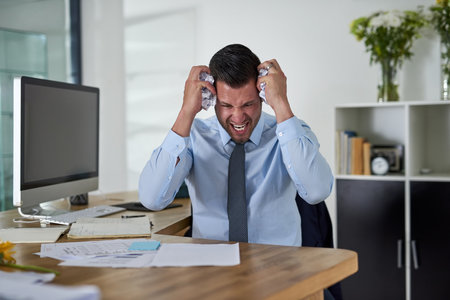 When will I see an end to these deadlines. Shot of a young businessman looking stressed out while...