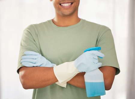 The undisputed master of cleaning. Shot of a man holding a spray bottle of detergent.