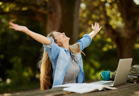 These exams have nothing on me. Shot of a young woman studying outdoors.