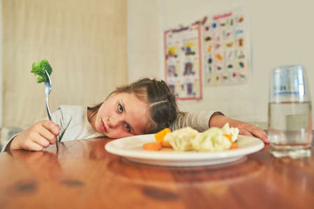 You cant make me eat this. Shot of a little girl refusing to eat her broccoli.の写真素材