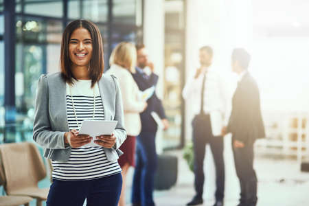 Another chance at success. Portrait of a young businesswoman using a digital tablet in an office.