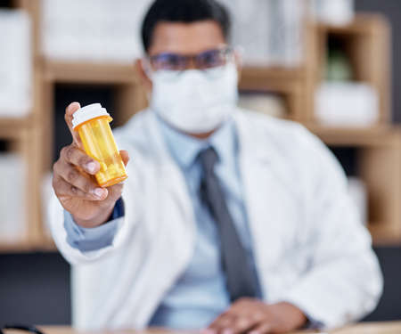 These meds come highly recommended. Closeup shot of an unrecognisable doctor holding a bottle of...